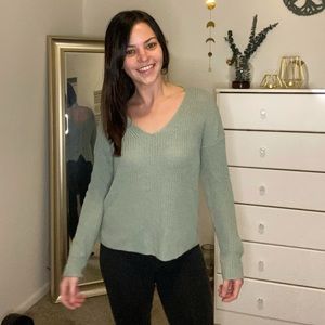 Women’s light teal sweater with a cross back
